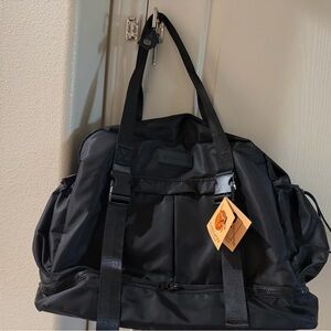 Classic Black Duffel Bag with Front Pocket and Strap Handles